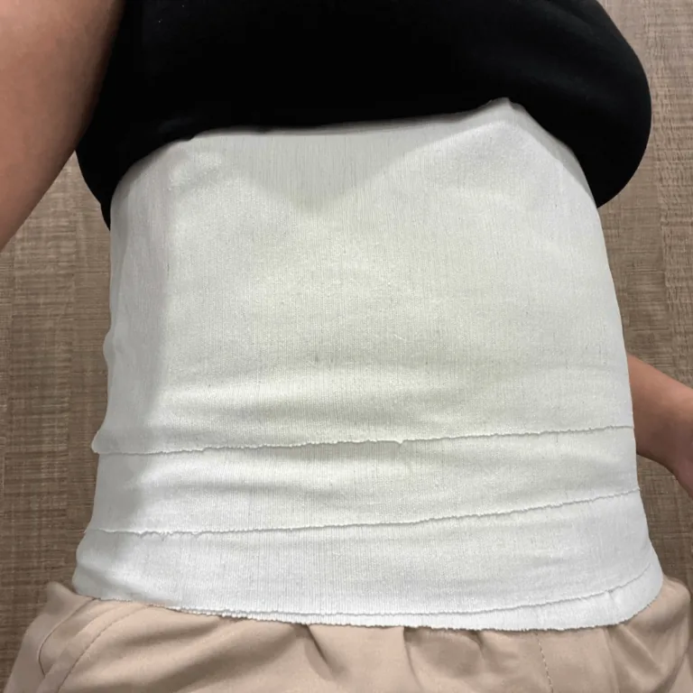 Postpartum mum wearing BMB's cotton bengkung wrap after a Jamu postnatal session